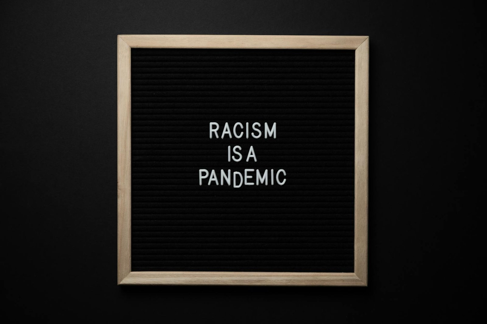 phrase racism is pandemic on signboard